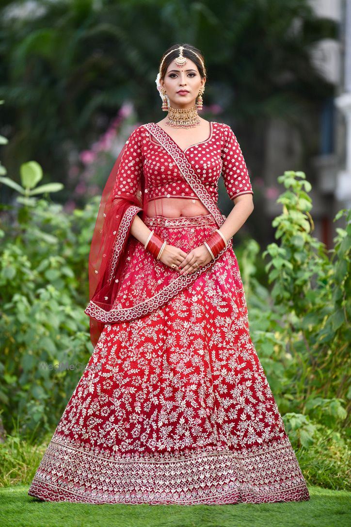 Bride in a red embroidered lehenga with veil