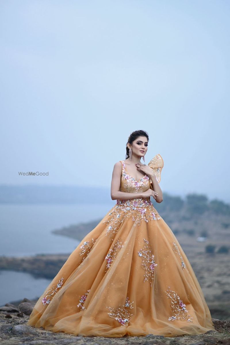Engagement look with gold gown by the lake